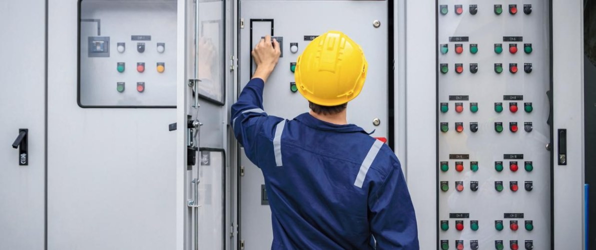 Engineer inspecting an electrical control panel